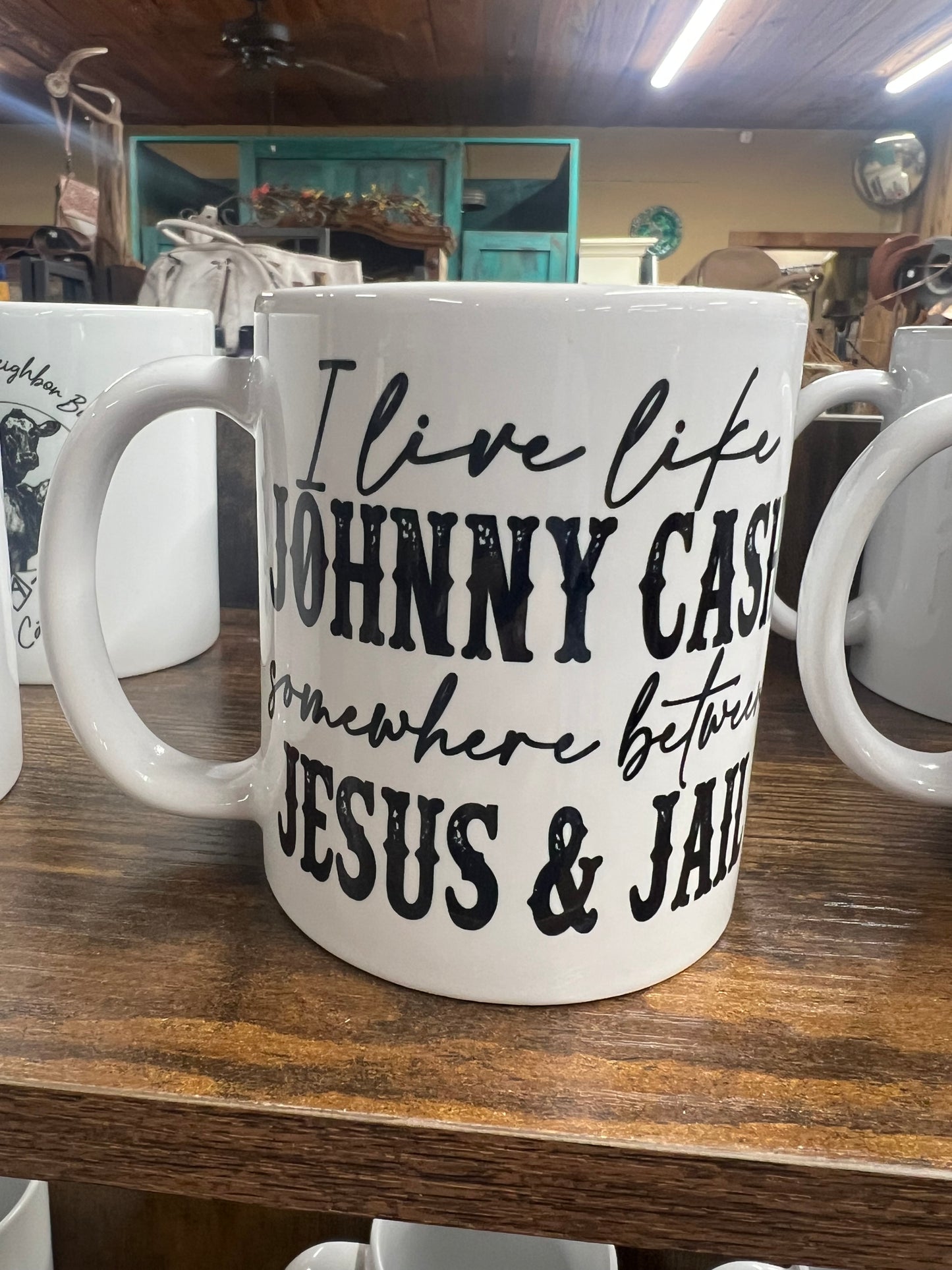 I live like Johnny Cash, somewhere between Jesus and jail coffee mug