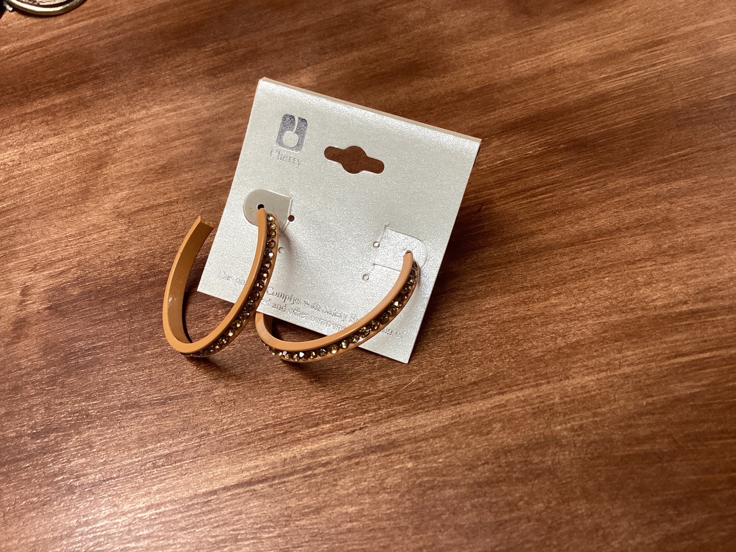 Tan hoop earrings with rhinestones