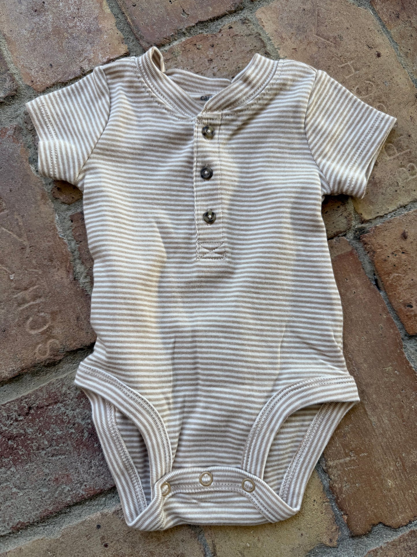 Tan and white Carter’s button up onesie