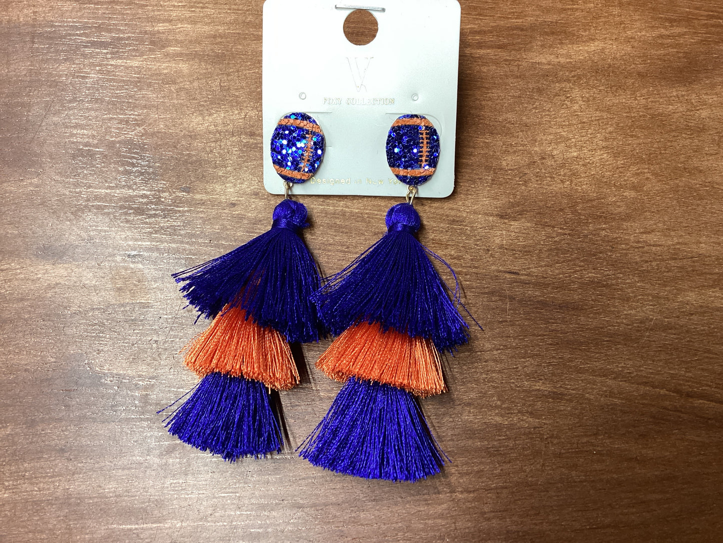 Blue glitter football earrings w/blue/orange tassel