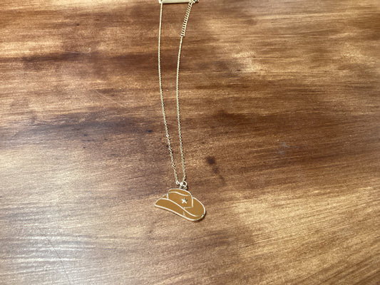 Brown cowboy hat on gold chain