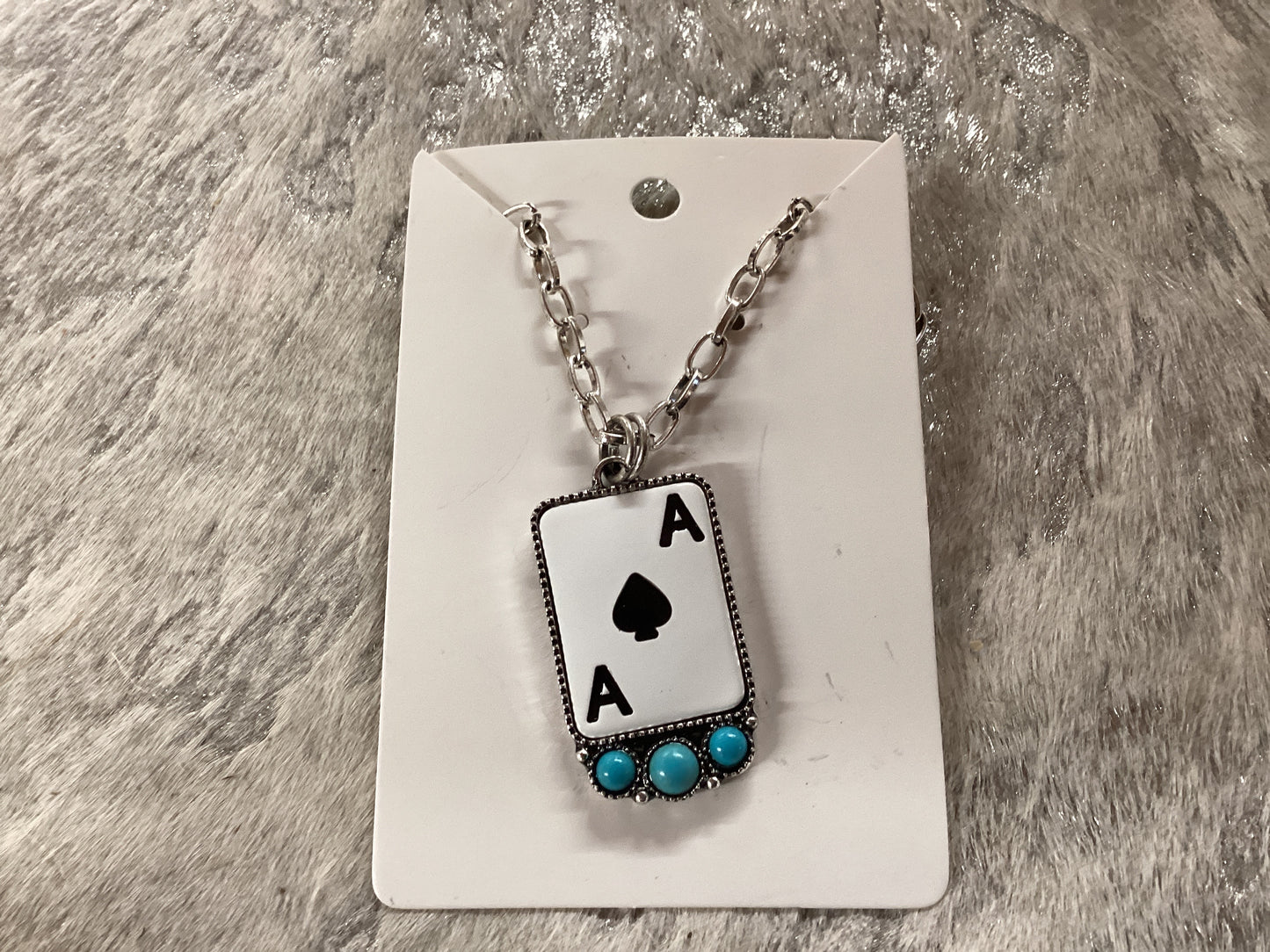 Ace card with turquoise silver necklace